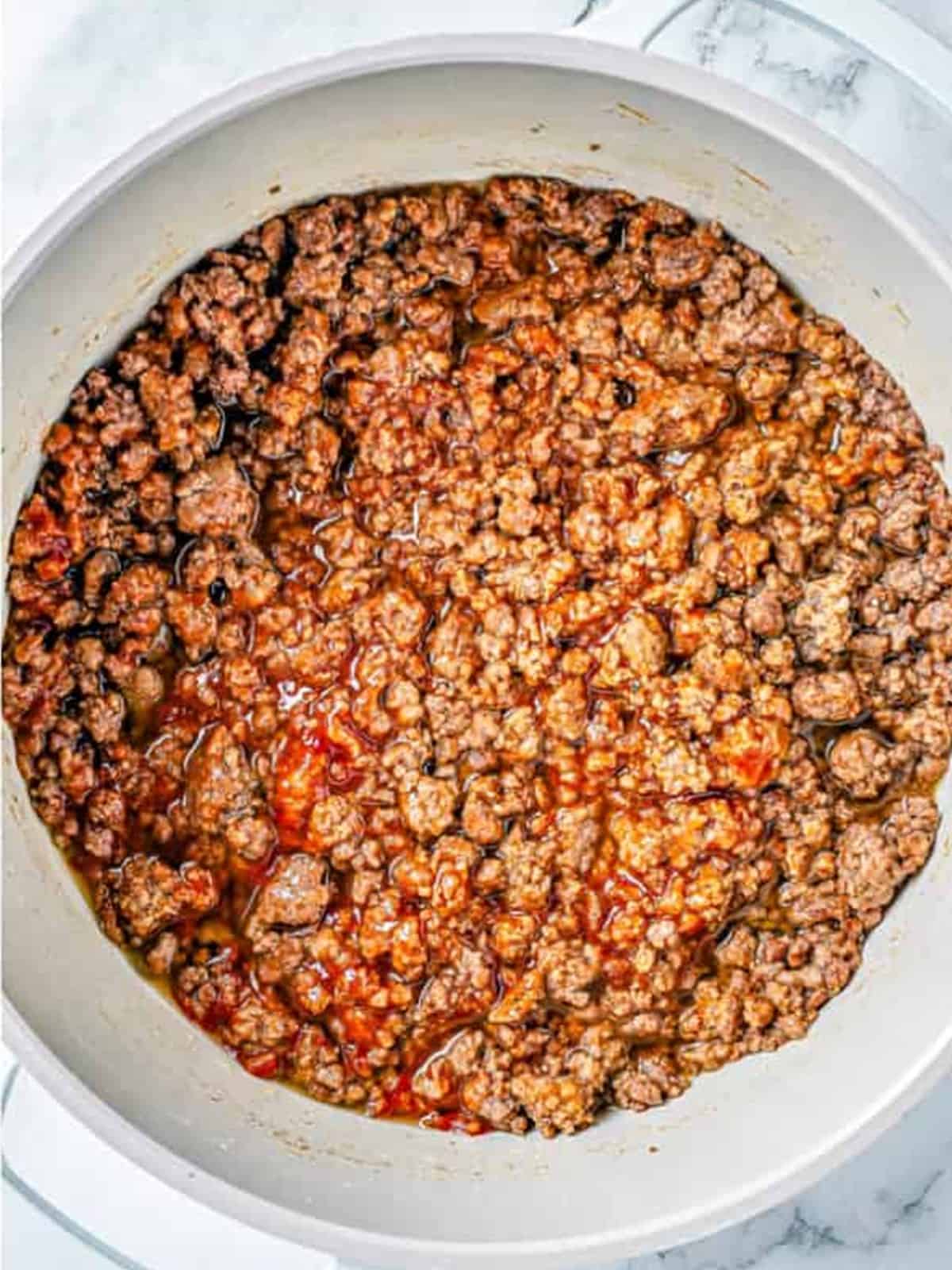 Garlic and Italian seasonings stirred into the browned ground beef.