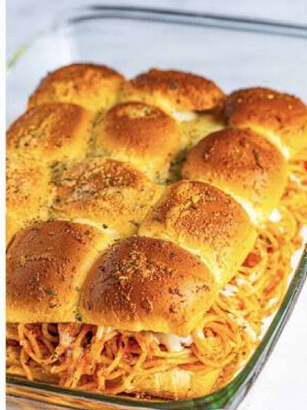 Golden baked spaghetti and meatball sliders fresh from the oven.