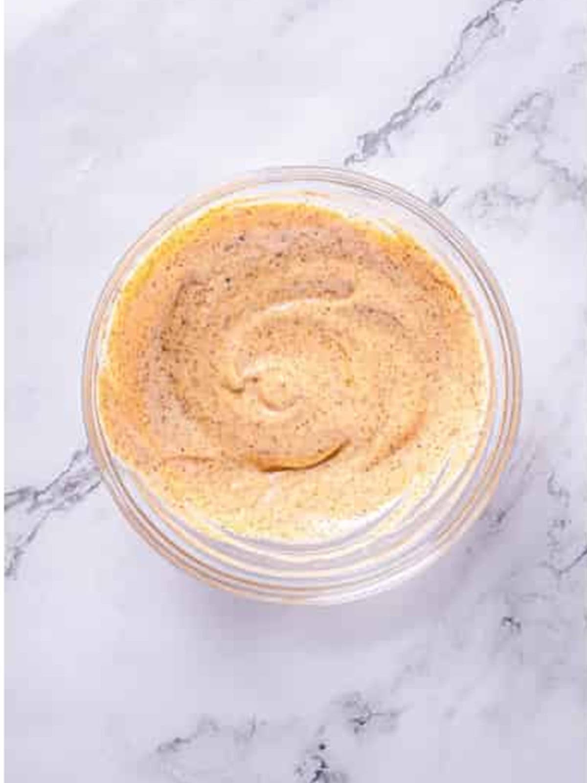 Chipotle mayo mixed in a glass bowl for Mexican street corn.
