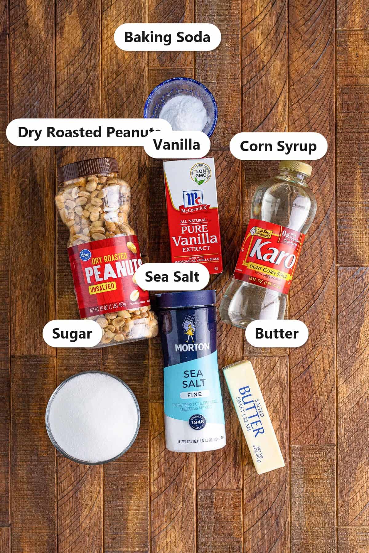 Labeled ingredients for microwave peanut brittle including sugar, corn syrup, dry roasted peanuts, sea salt, butter, vanilla, and baking soda.