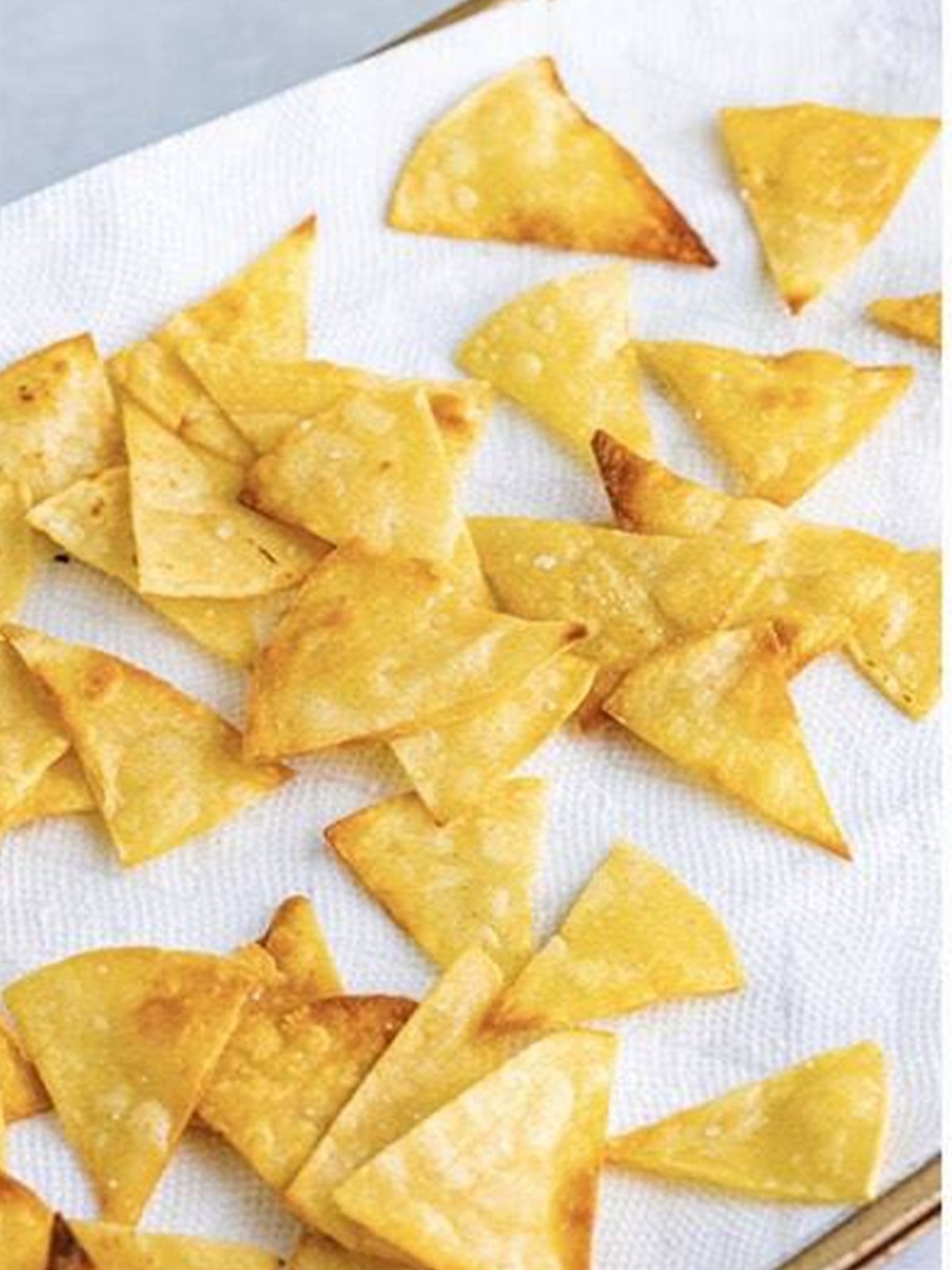 Crisped corn tortilla strips on a plate for migas.
