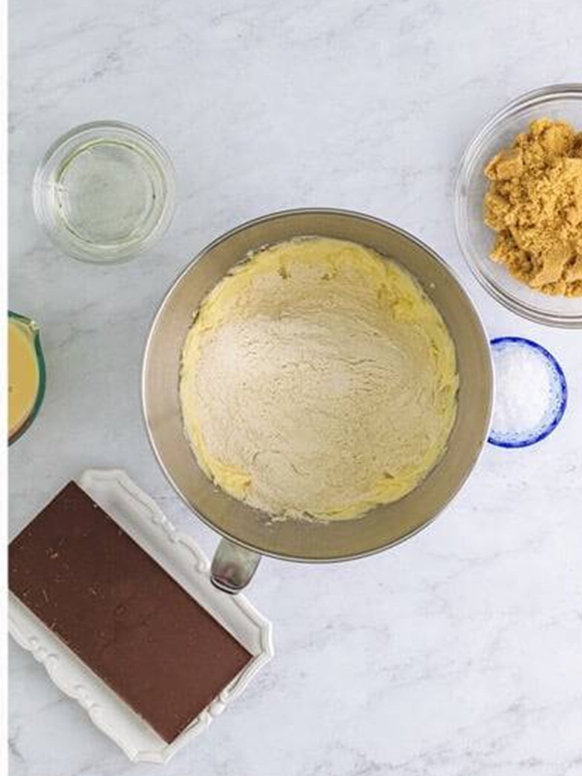 Crumbly shortbread dough mixed in a bowl for millionaires shortbread.