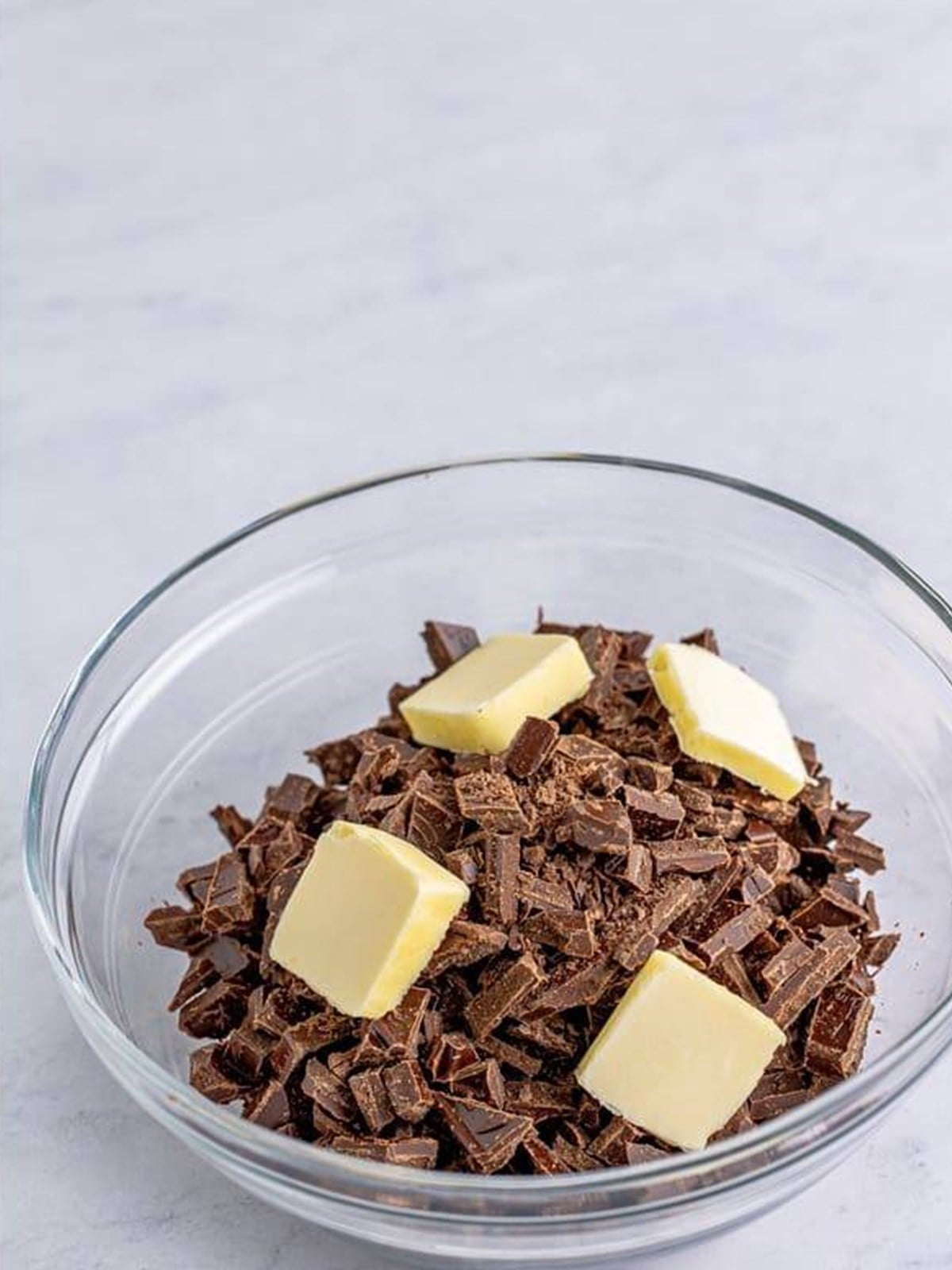 Chopped chocolate and butter in a bowl ready to melt for the topping.