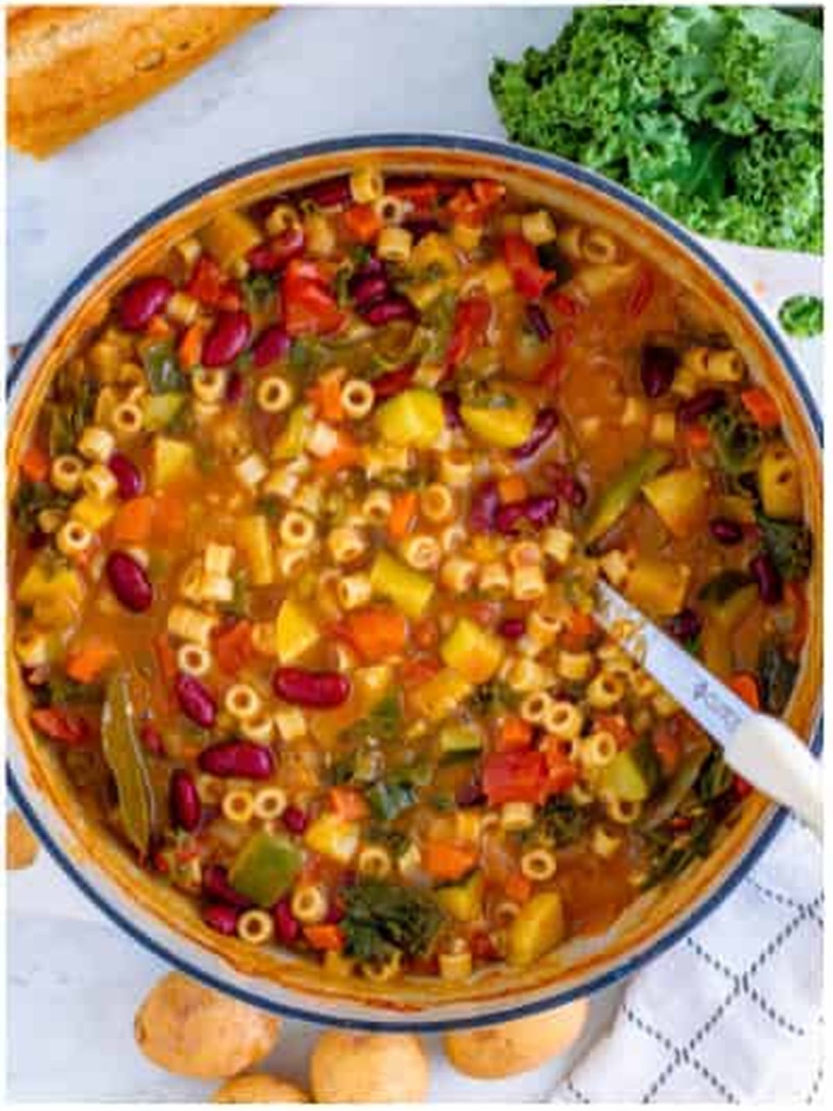 Finished minestrone soup with pasta, beans, and vegetables in a pot.