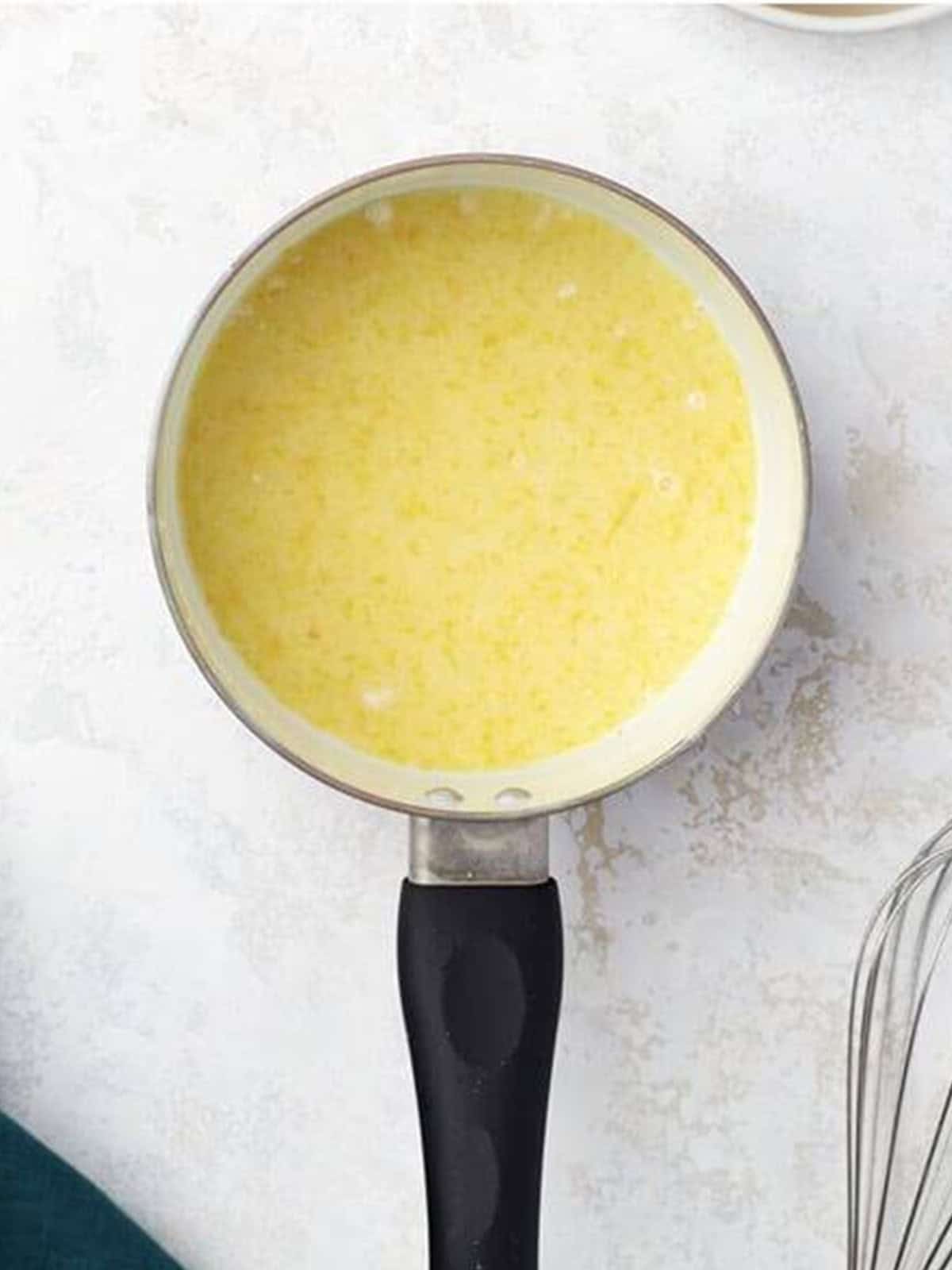 Lemon juice, water, flour, and cornstarch cooking in a small saucepan.