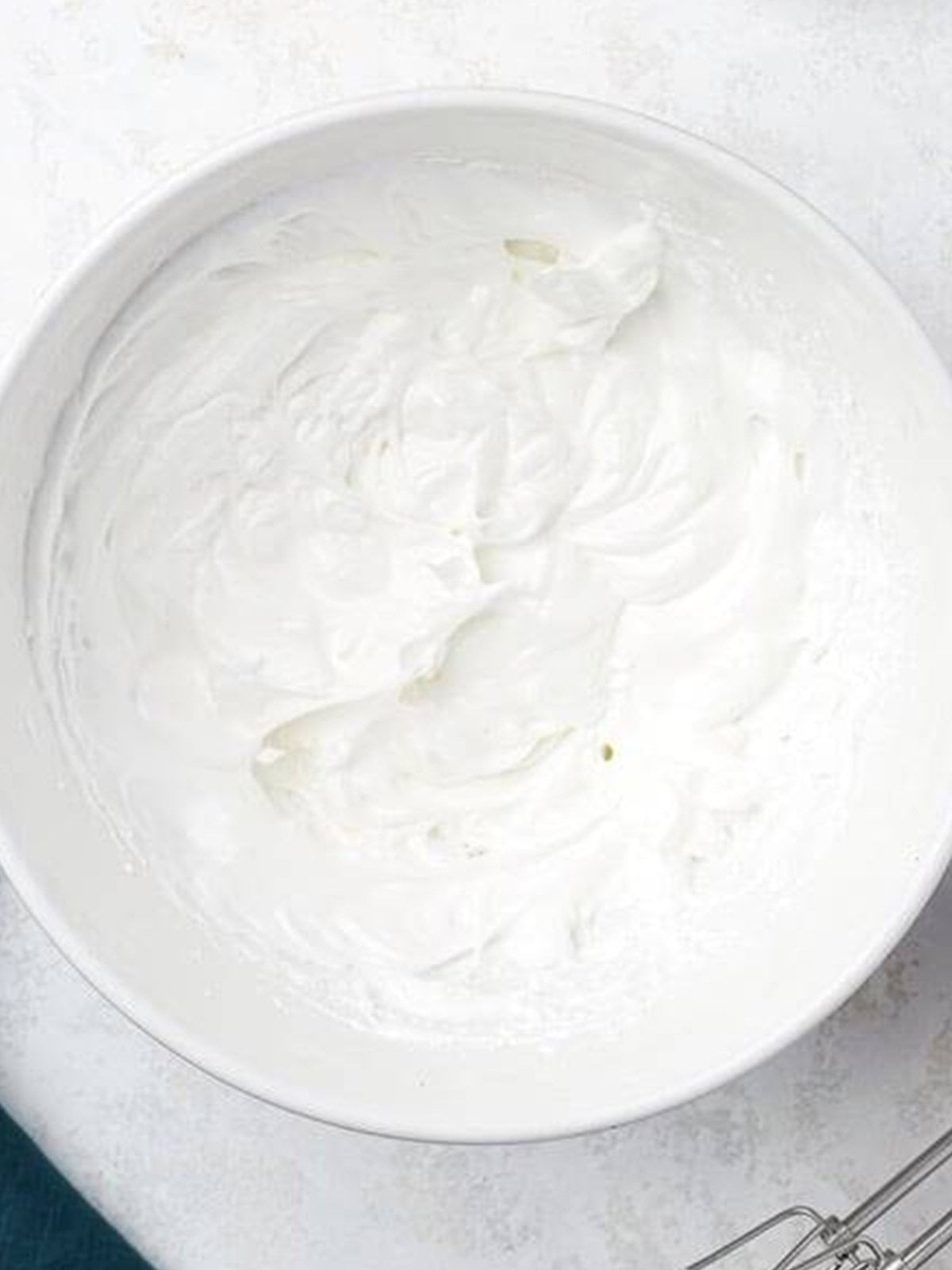 Egg whites whipped with sugar and cream of tartar into stiff glossy meringue.