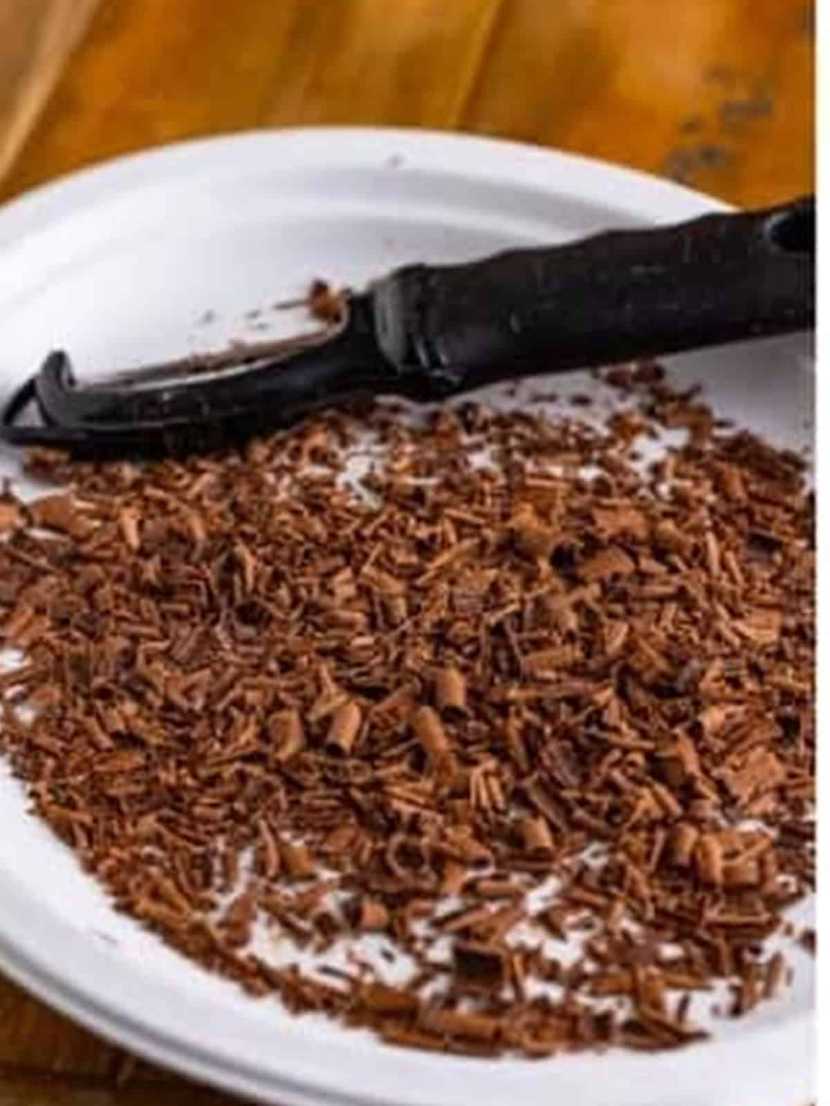 Shaved semi-sweet chocolate on a plate for mint chocolate chip ice cream.