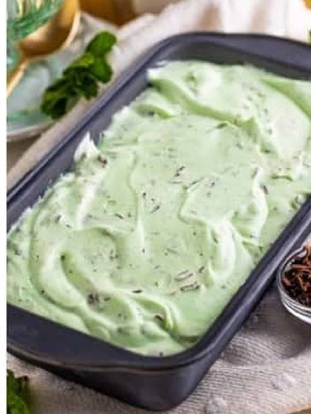 Smoothed mint chocolate chip ice cream in a loaf pan ready to freeze.
