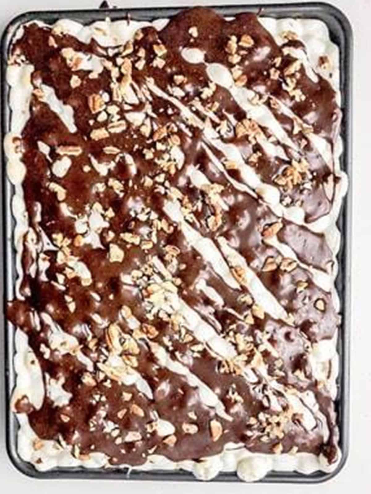 Mississippi mud brownie bars drizzled with chocolate sauce and topped with pecans.