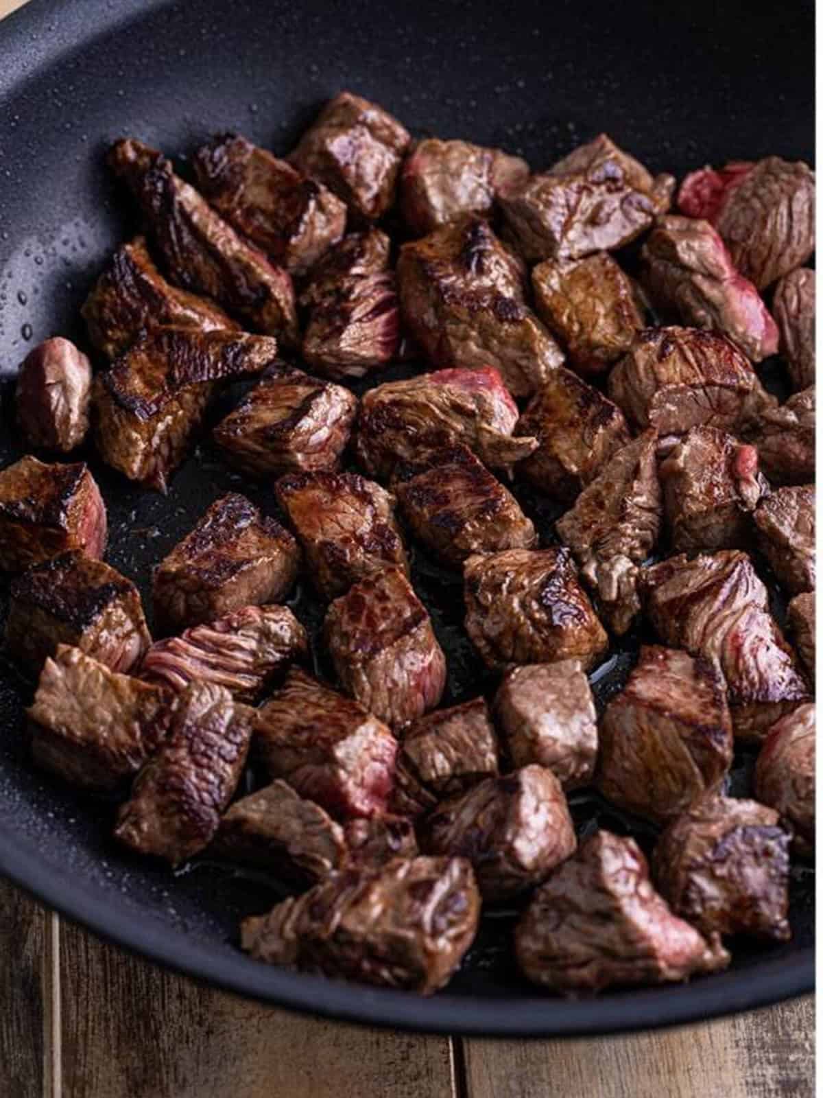 Cubed sirloin steak seared until browned in a hot skillet for Mississippi steak bites.