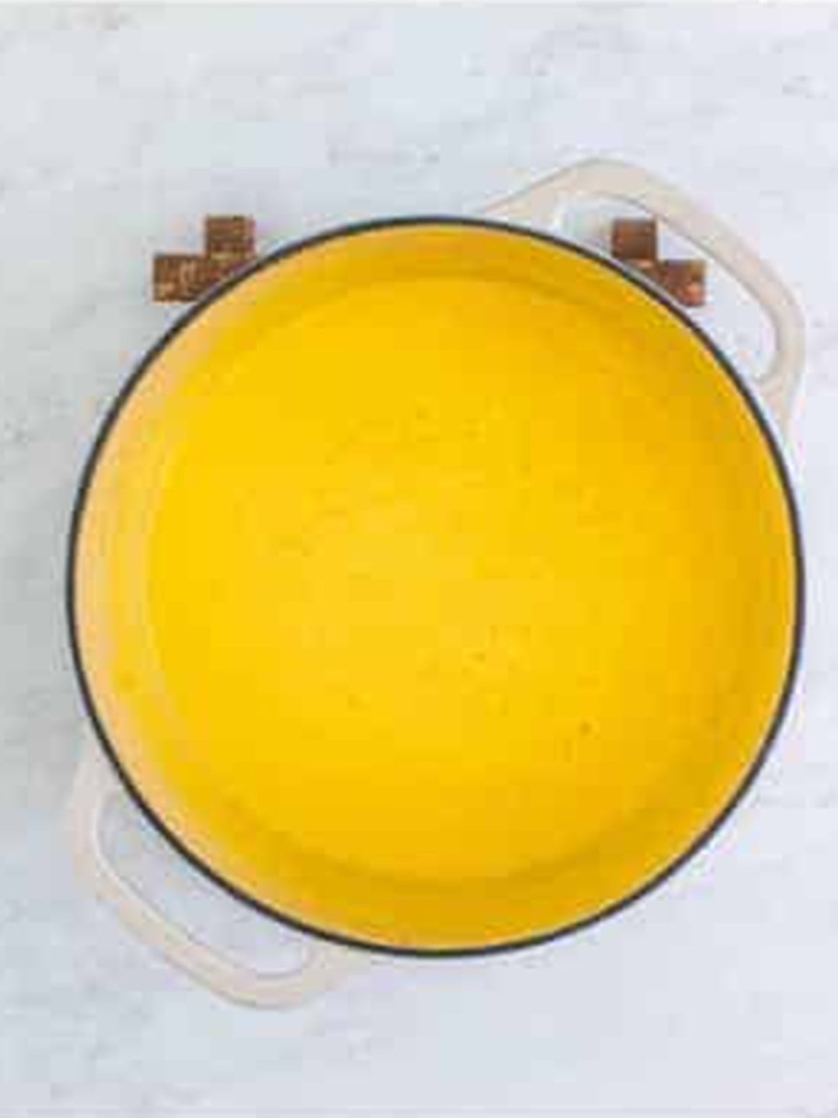 Smooth cheese sauce made in a Dutch oven for mac and cheese.