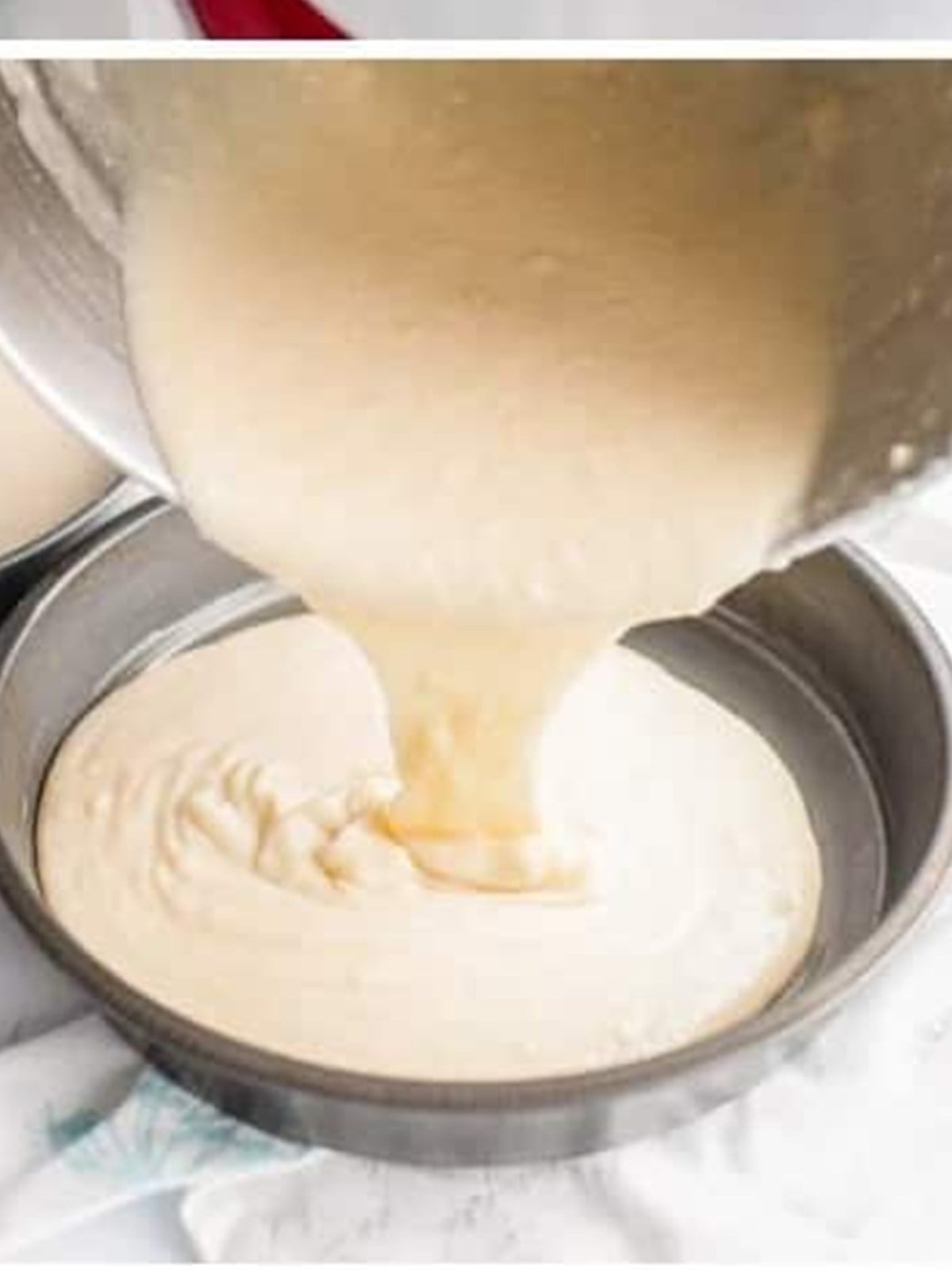 Vanilla cake batter poured into a round cake pan.