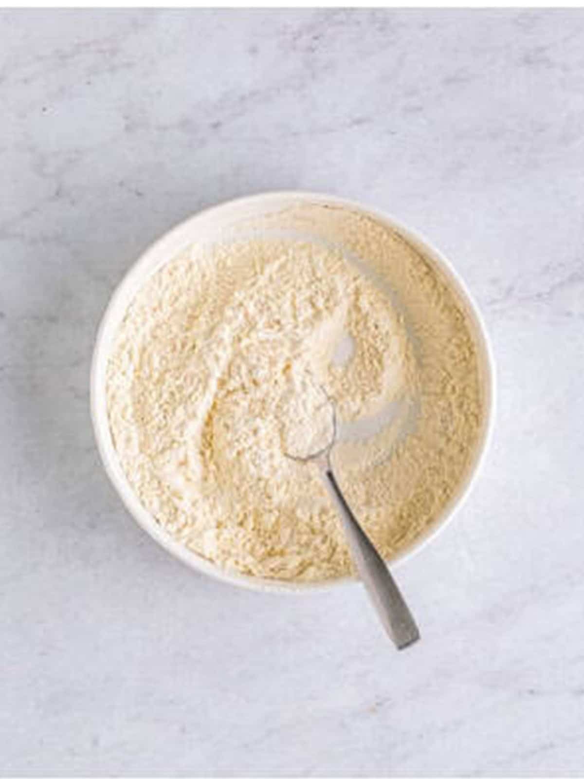 Flour, baking soda, baking powder, and salt whisked in a small bowl.
