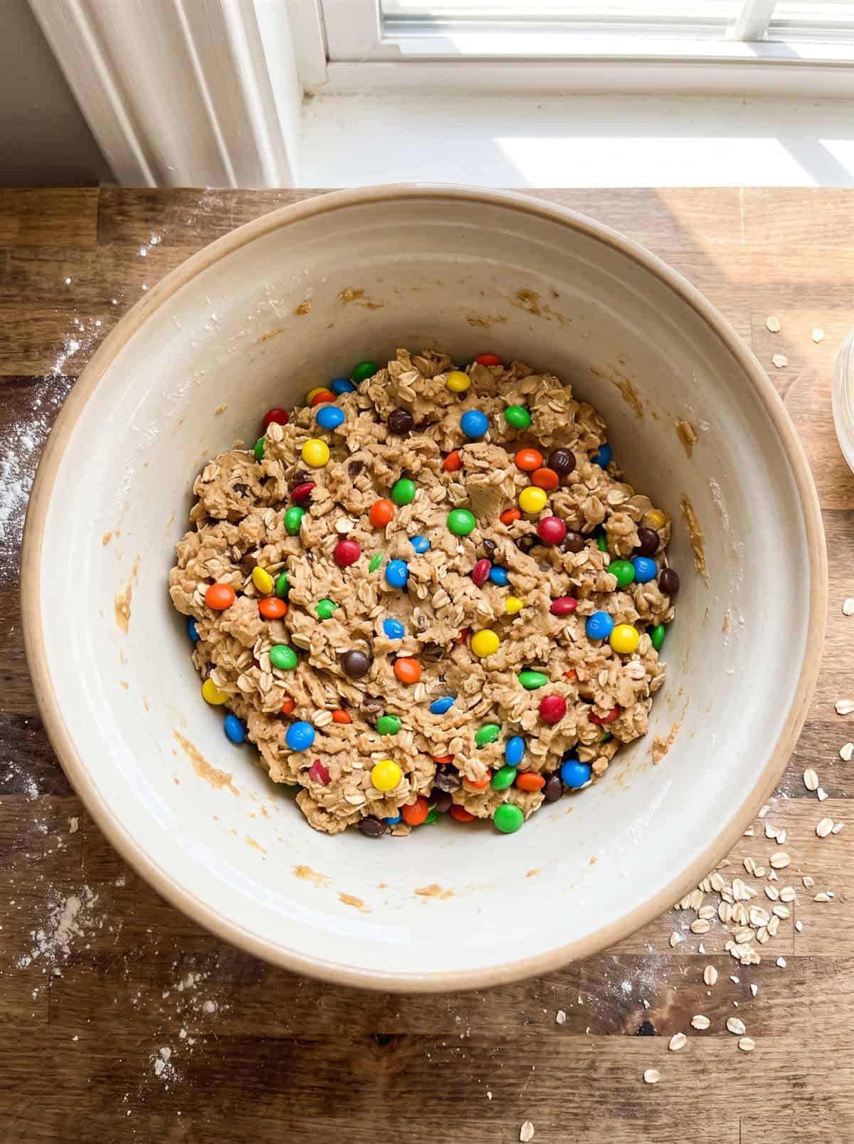 Monster cookie dough with oats and colorful candy pieces in a bowl.
