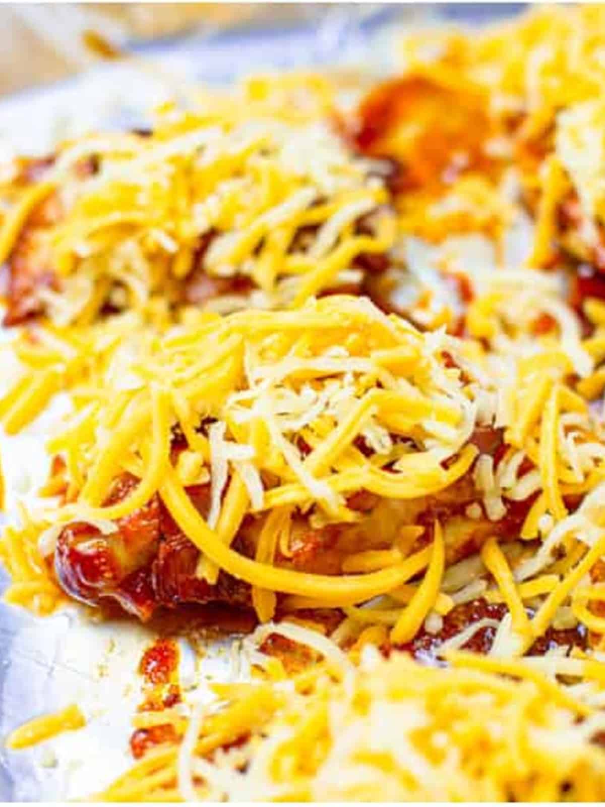 BBQ chicken topped with shredded colby jack cheese melting on top.