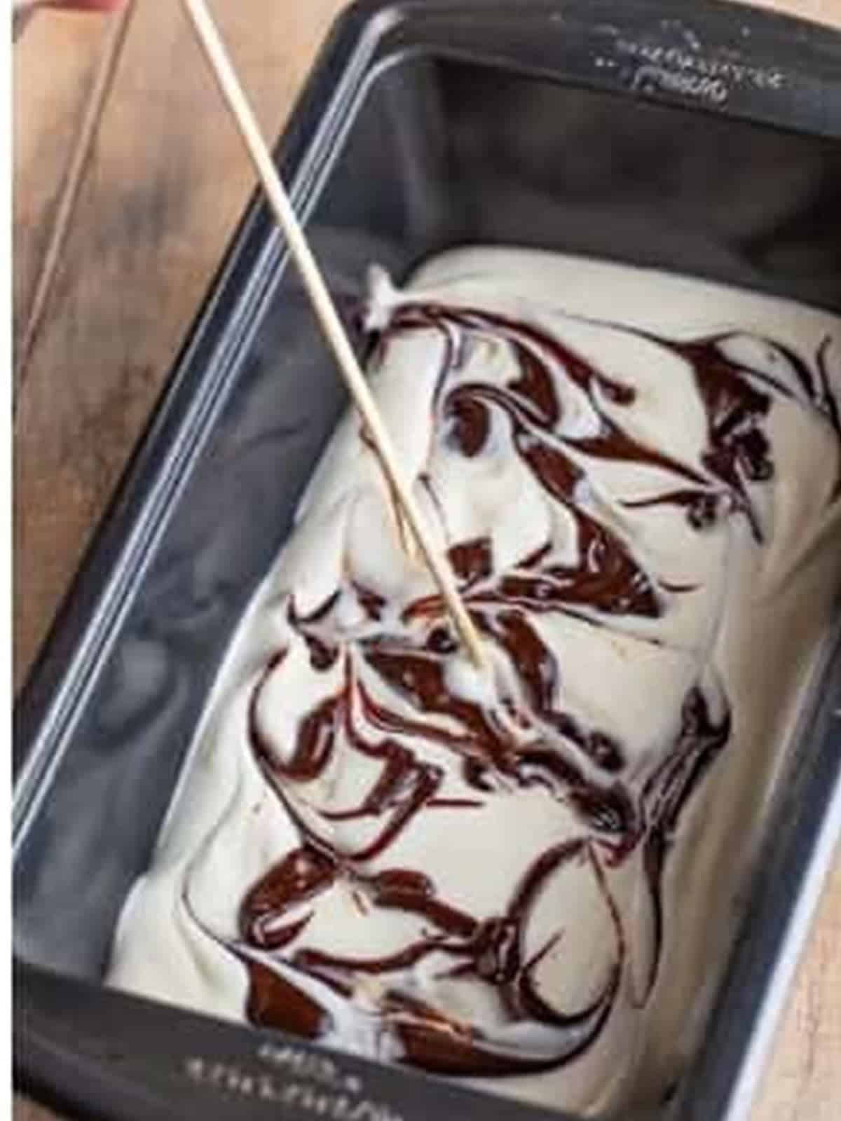 Hot fudge swirled through the moose tracks ice cream with a skewer.