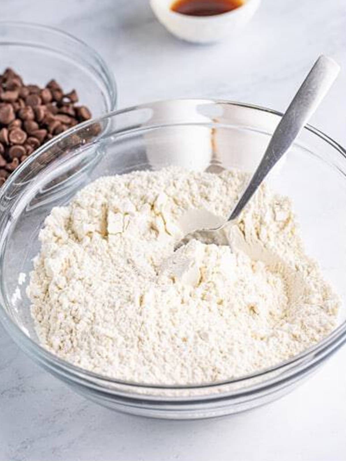 Flour, baking soda, and salt whisked together in a glass bowl.