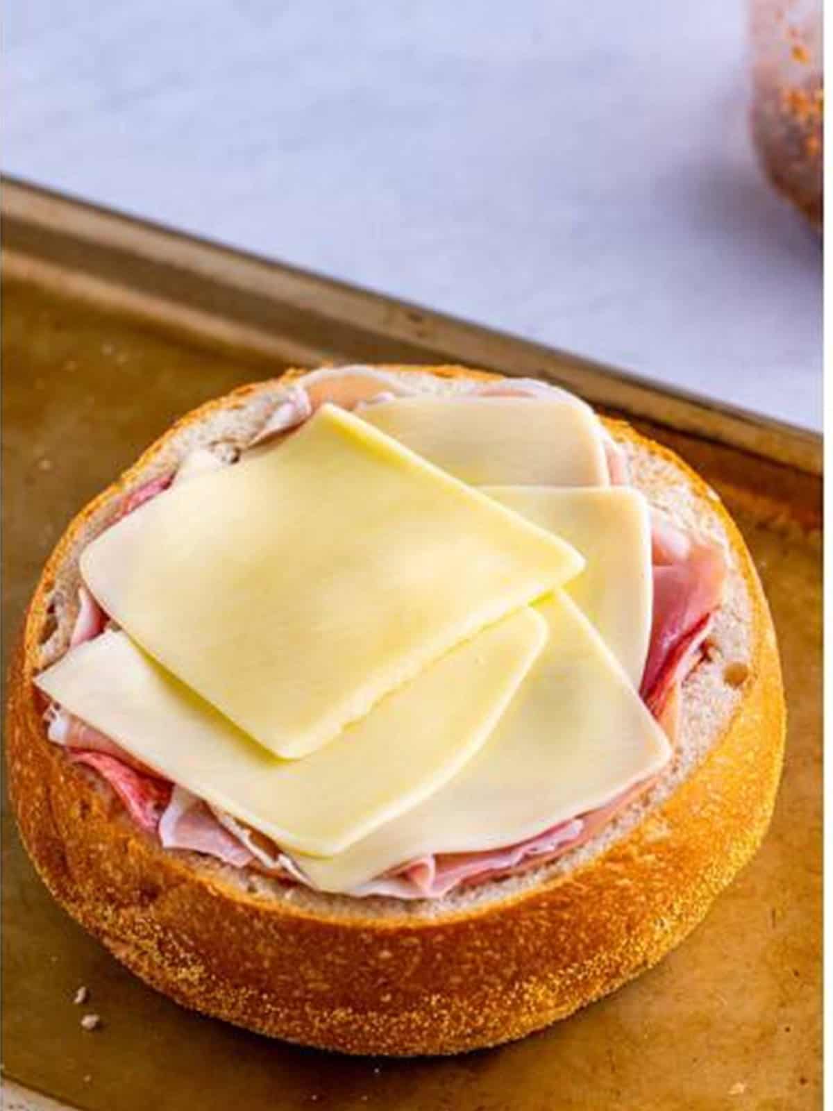 Provolone, ham, salami, prosciutto, and mozzarella layered inside the muffuletta bread.