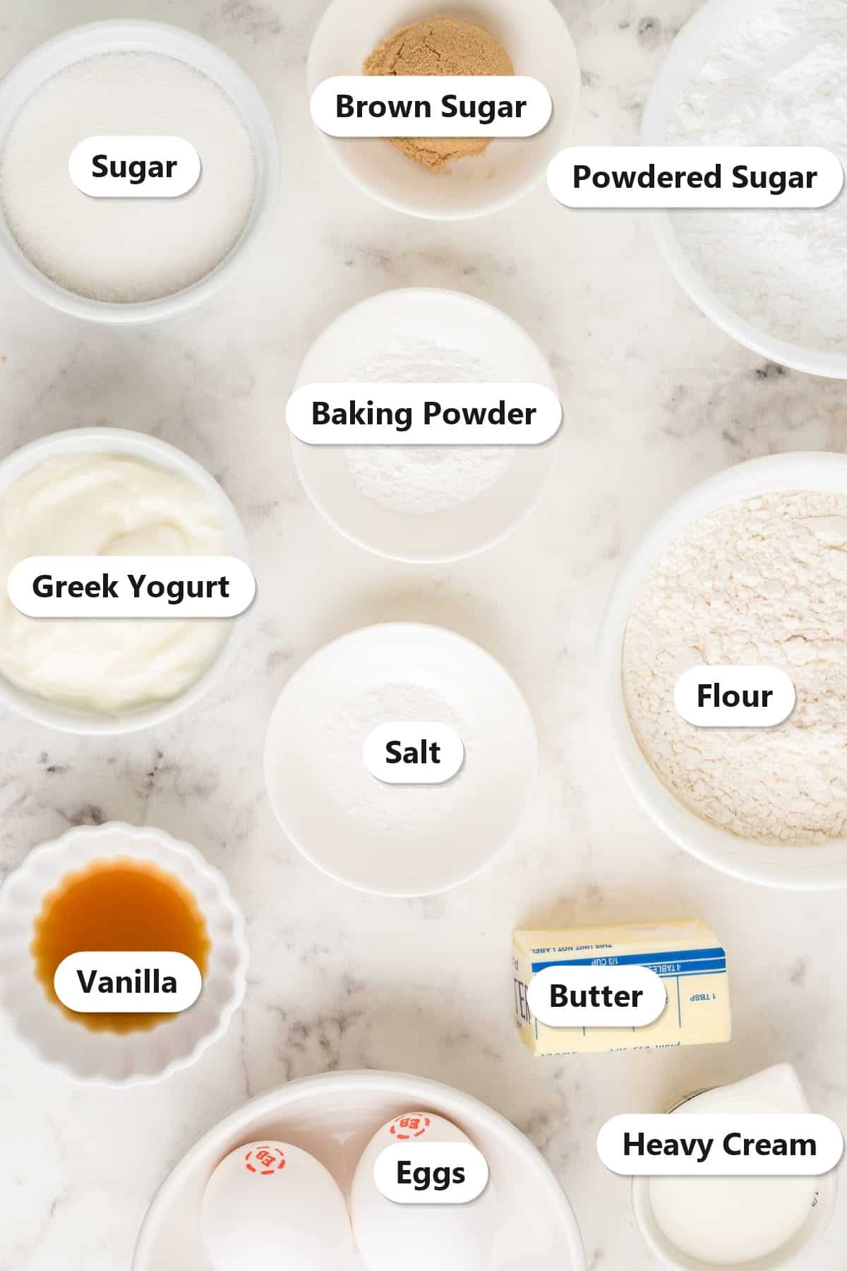 Labeled ingredients for homemade munchkins: sugar, brown sugar, powdered sugar, baking powder, Greek yogurt, salt, flour, vanilla, butter, eggs, and heavy cream.