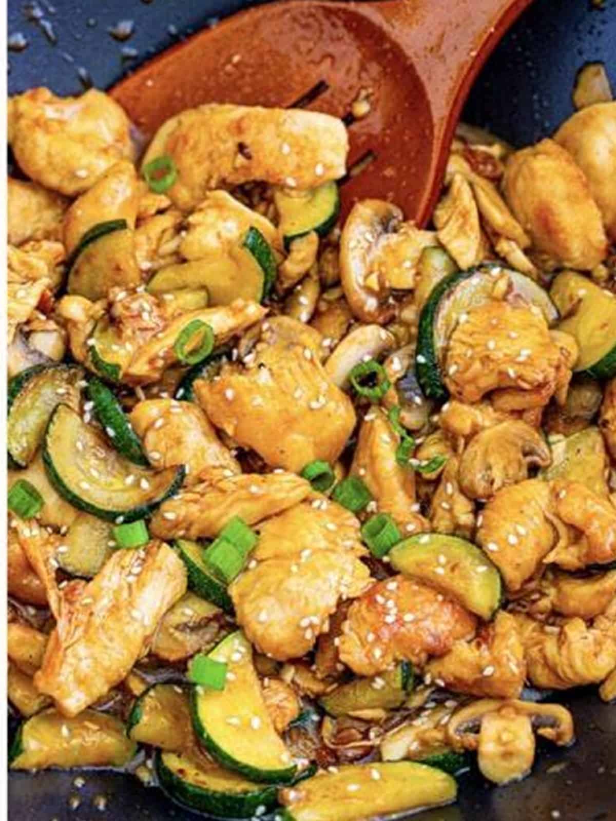 Finished copycat Panda Express mushroom chicken tossed in glossy sauce with scallions.