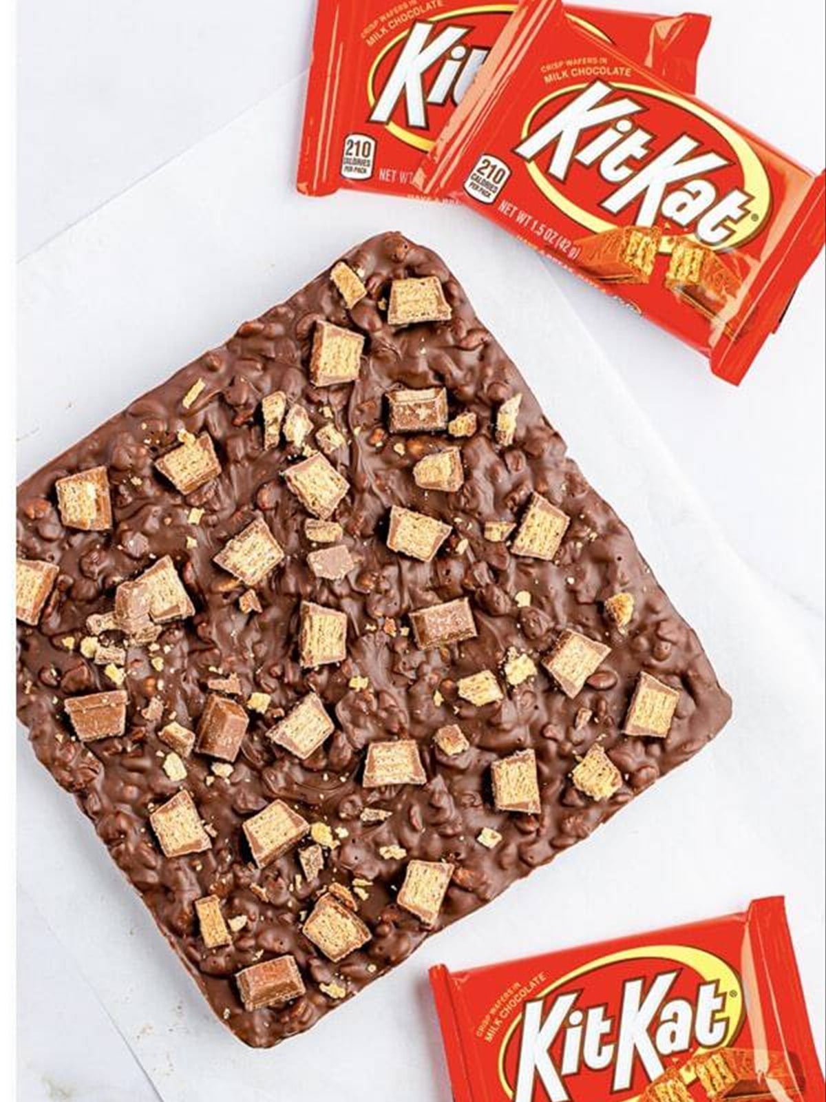 Nestle crunch bars cut into squares next to Kit Kat bars.