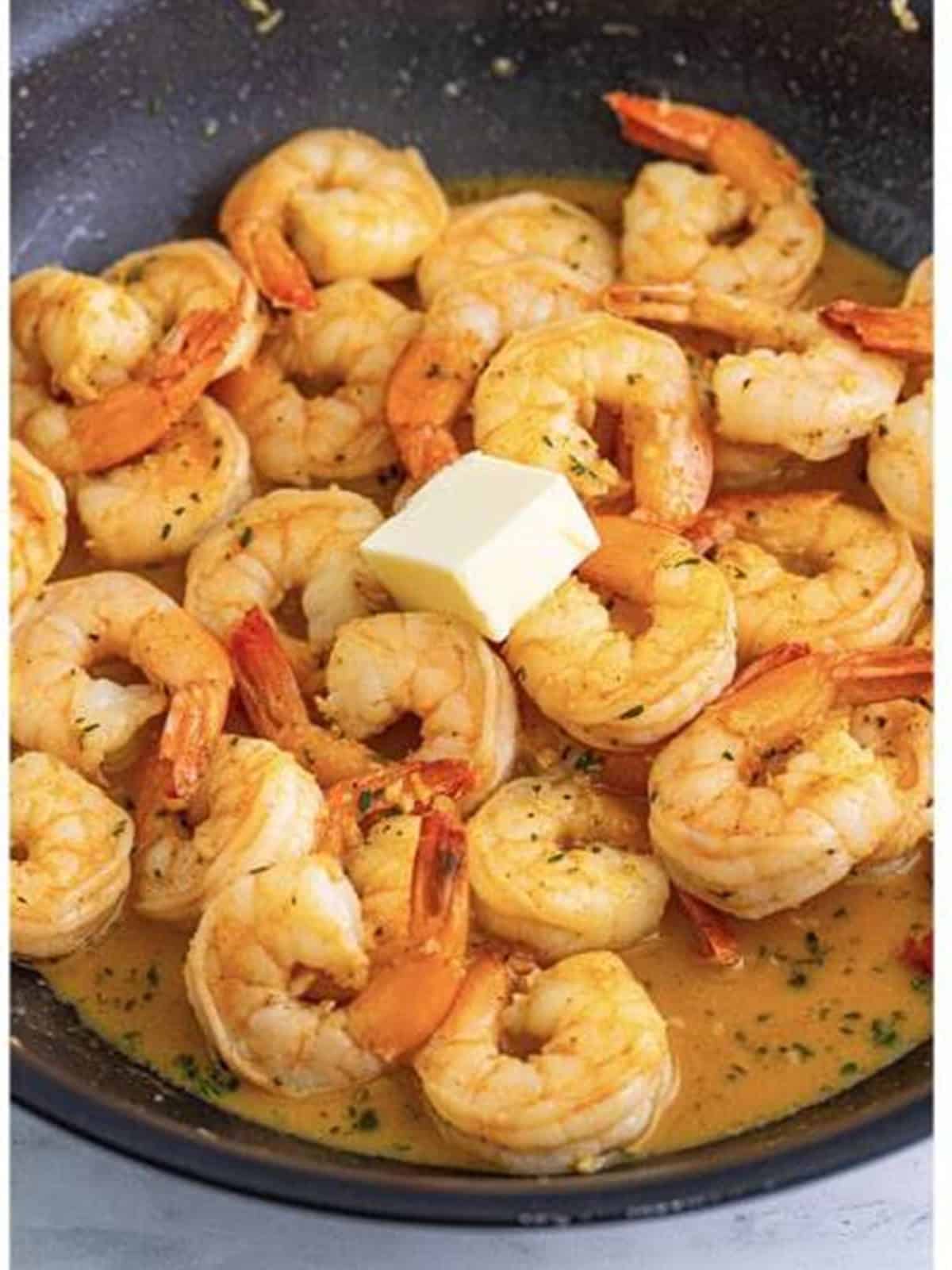 Cold butter stirred into the simmering sauce to make a velvety New Orleans BBQ shrimp sauce.