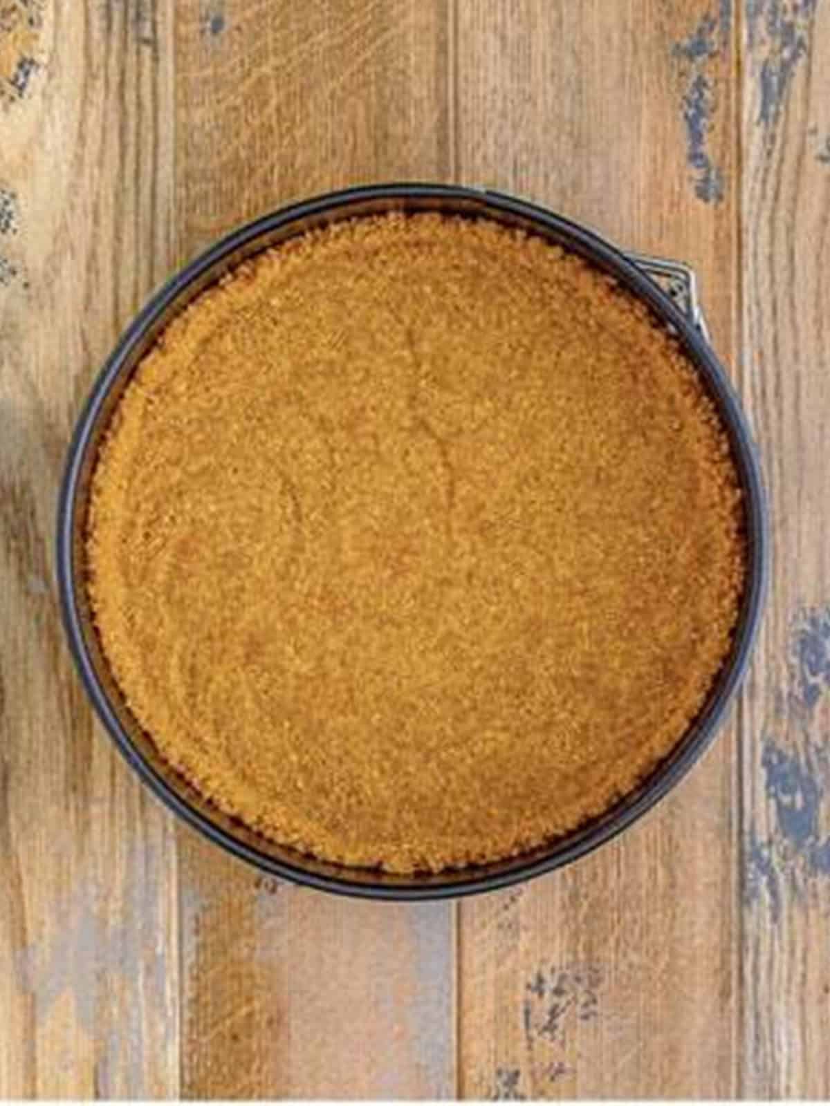Graham cracker crust pressed into a springform pan.