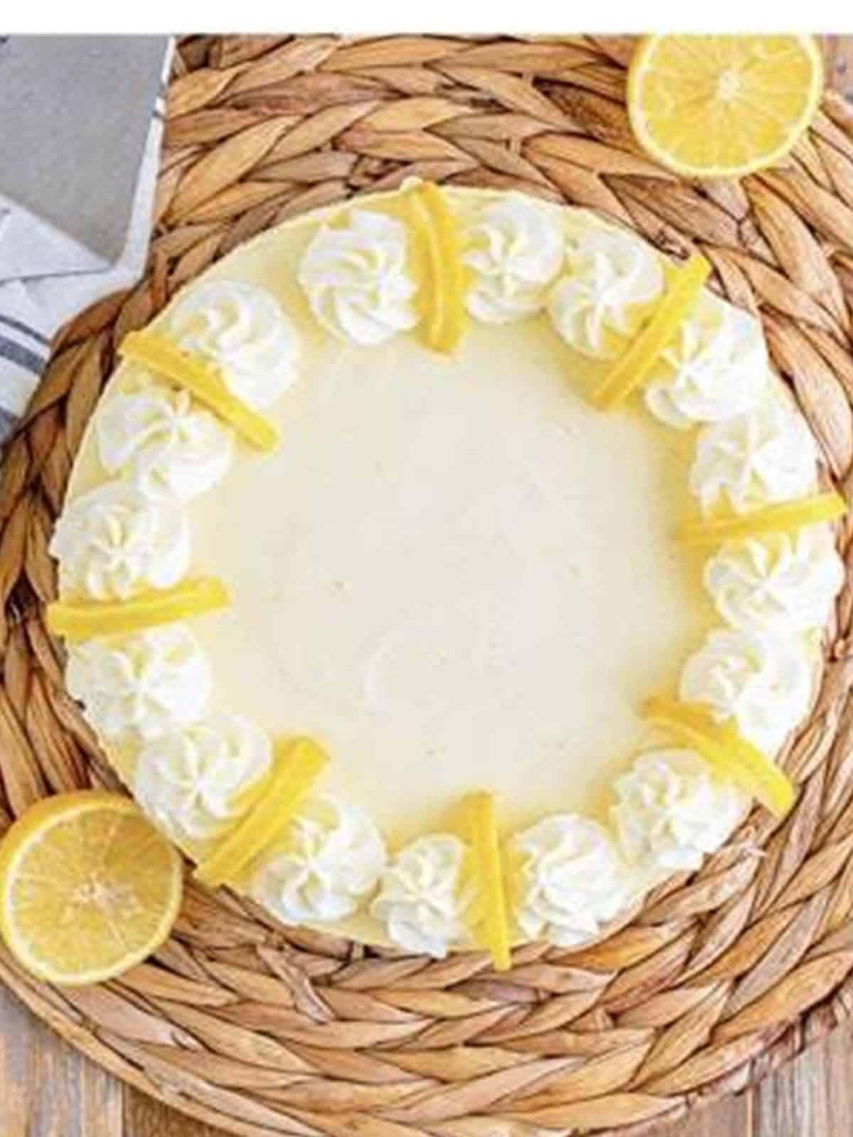 Finished no-bake lemon pie garnished with whipped cream and lemon.
