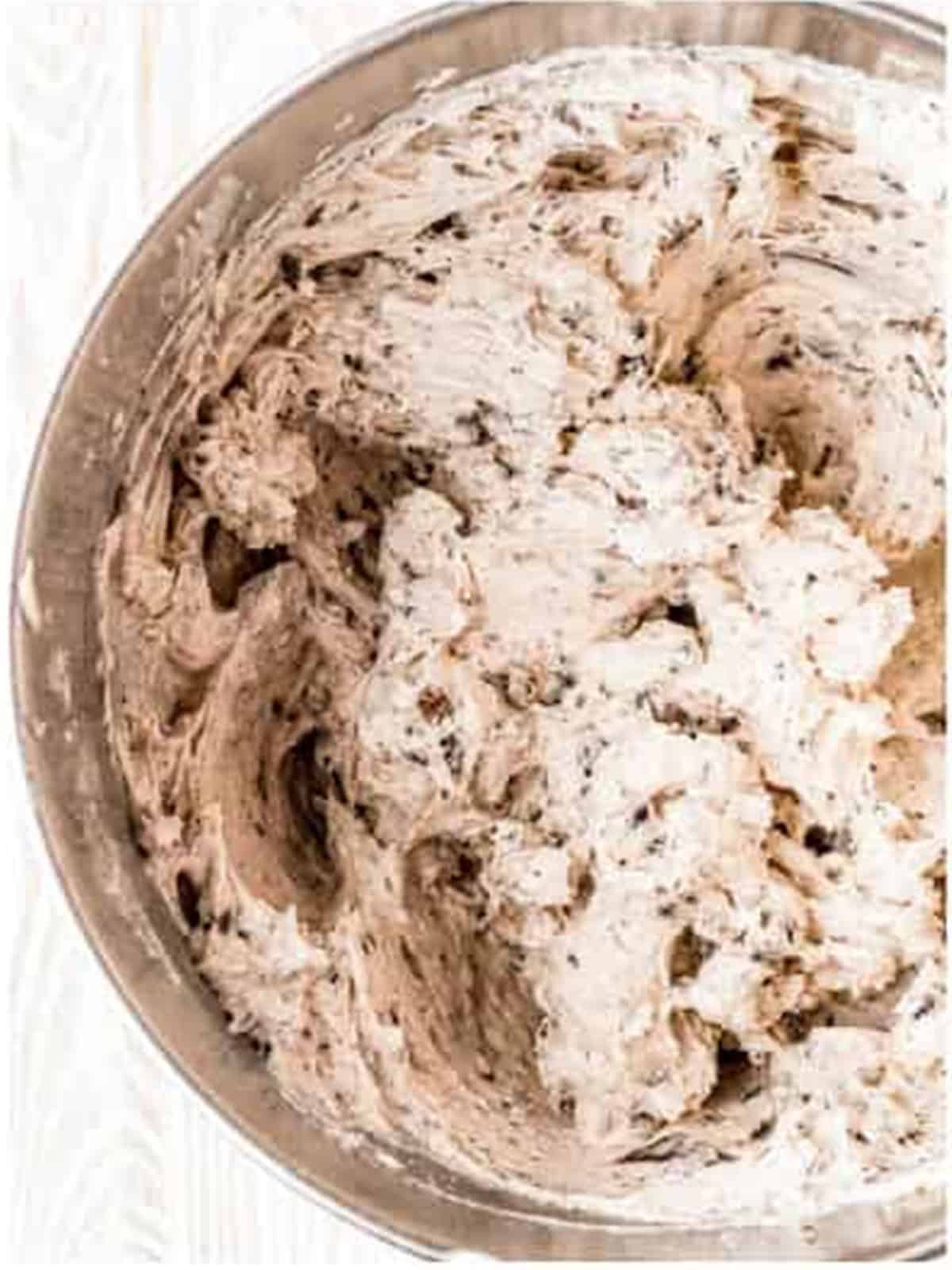 Cool Whip and crushed Oreos folded into the cookies and cream cheesecake filling.