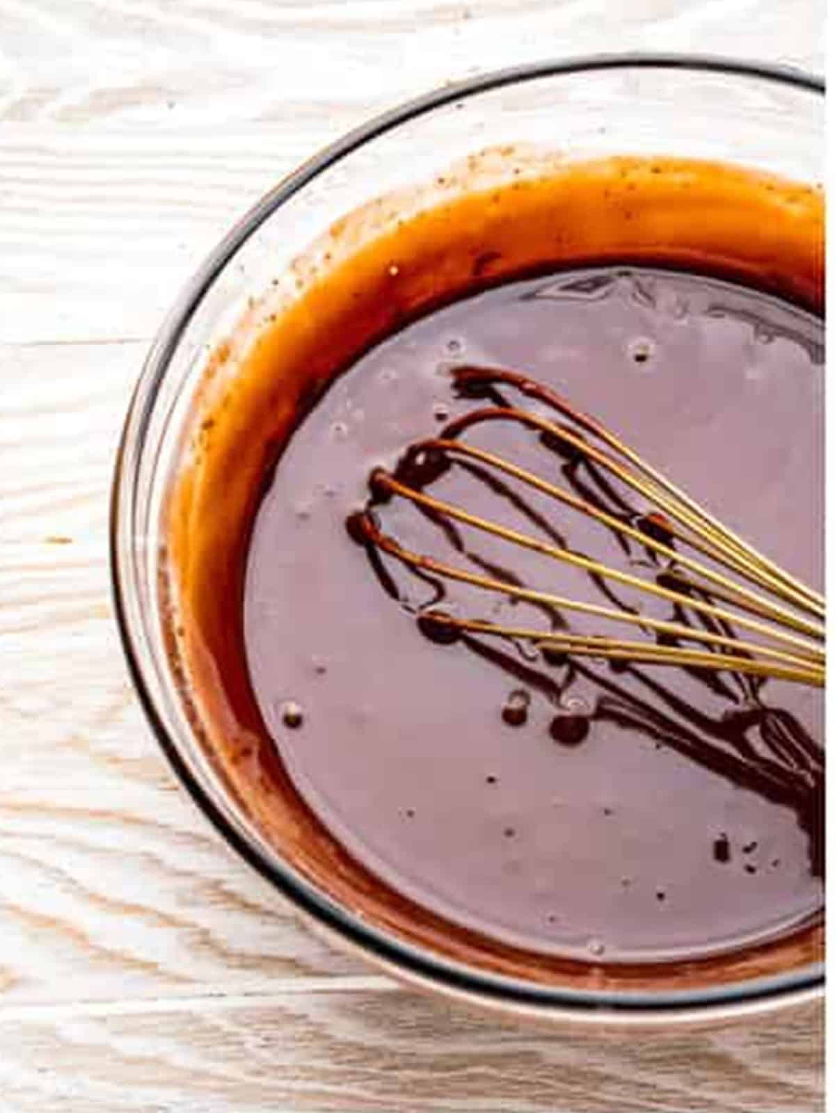 Chocolate ganache whisked smooth to pour over no bake Oreo cheesecake.