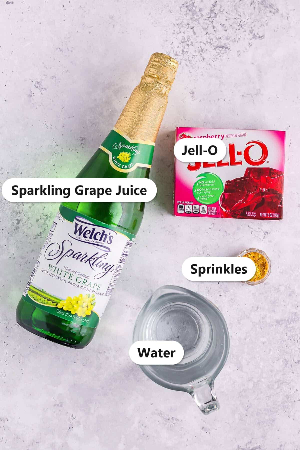 Non alcoholic jello shots ingredients labeled including sparkling grape juice, Jell-O, sprinkles, and water.