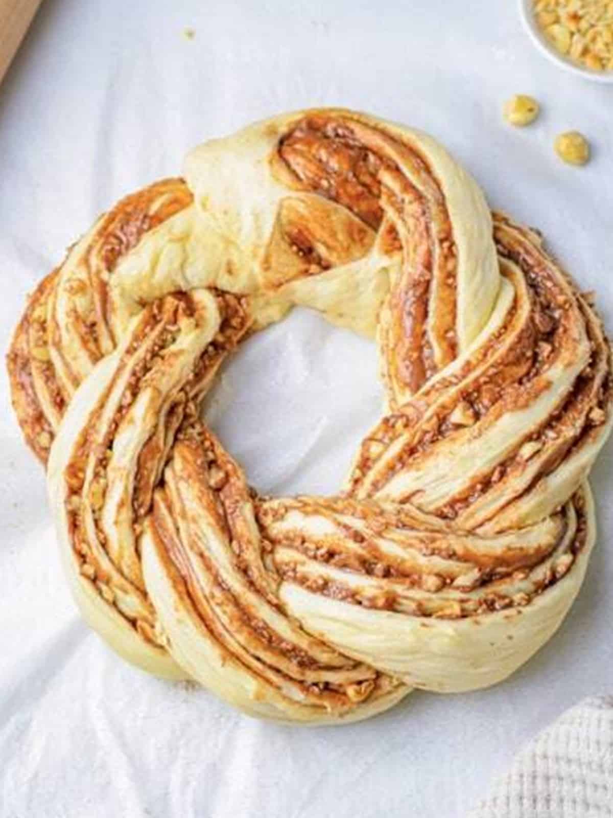 Twisted Nutella dough shaped into a braided wreath.