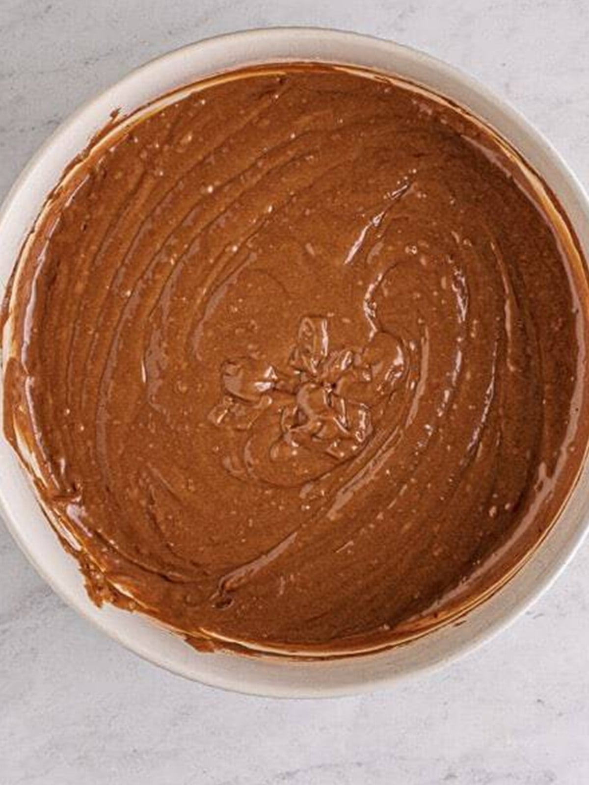 Smooth chocolate batter for Nutella Muffins in a bowl.
