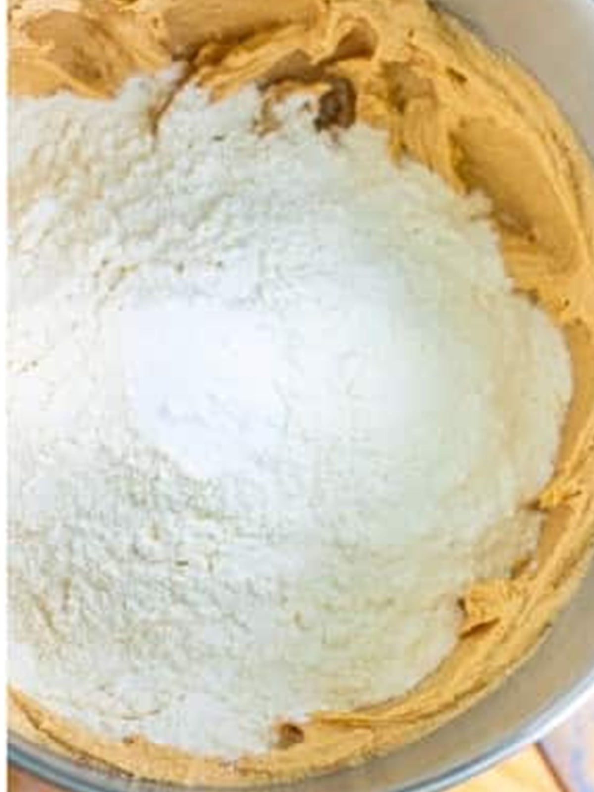 Mixing flour and baking soda into the nutter butter cookie dough.