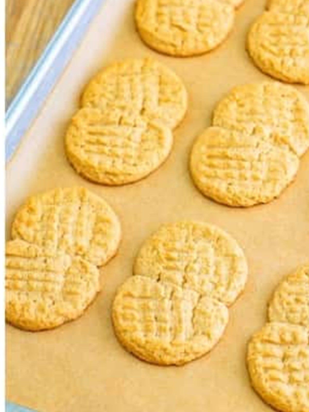 Golden baked peanut butter cookies on a baking tray.