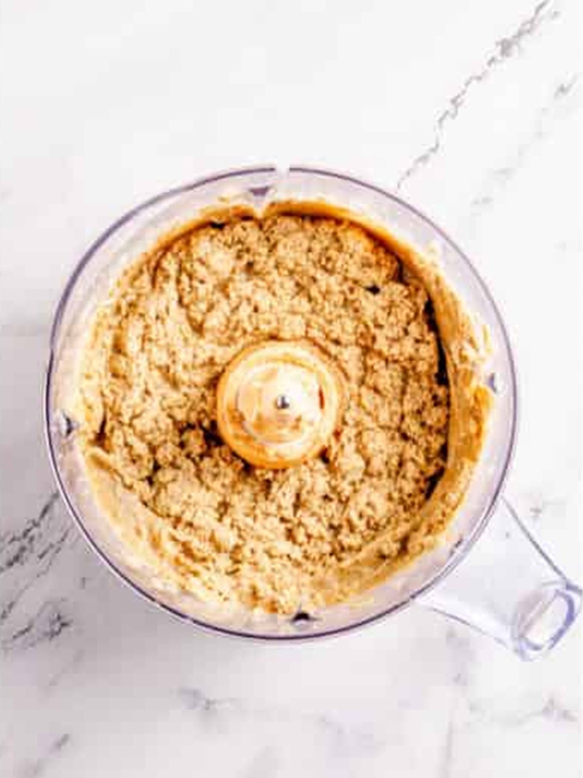 Oats and flour added to the creamed butter mixture for oatmeal cookie dough.