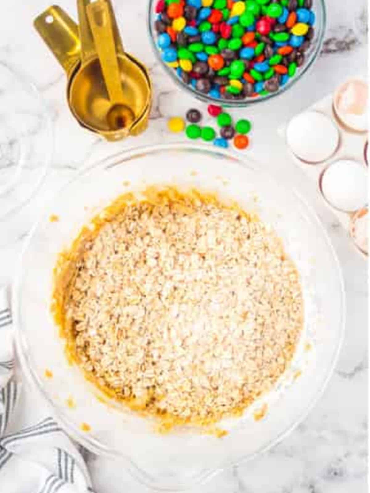 Quick oats added on top of the cookie dough in the mixing bowl.
