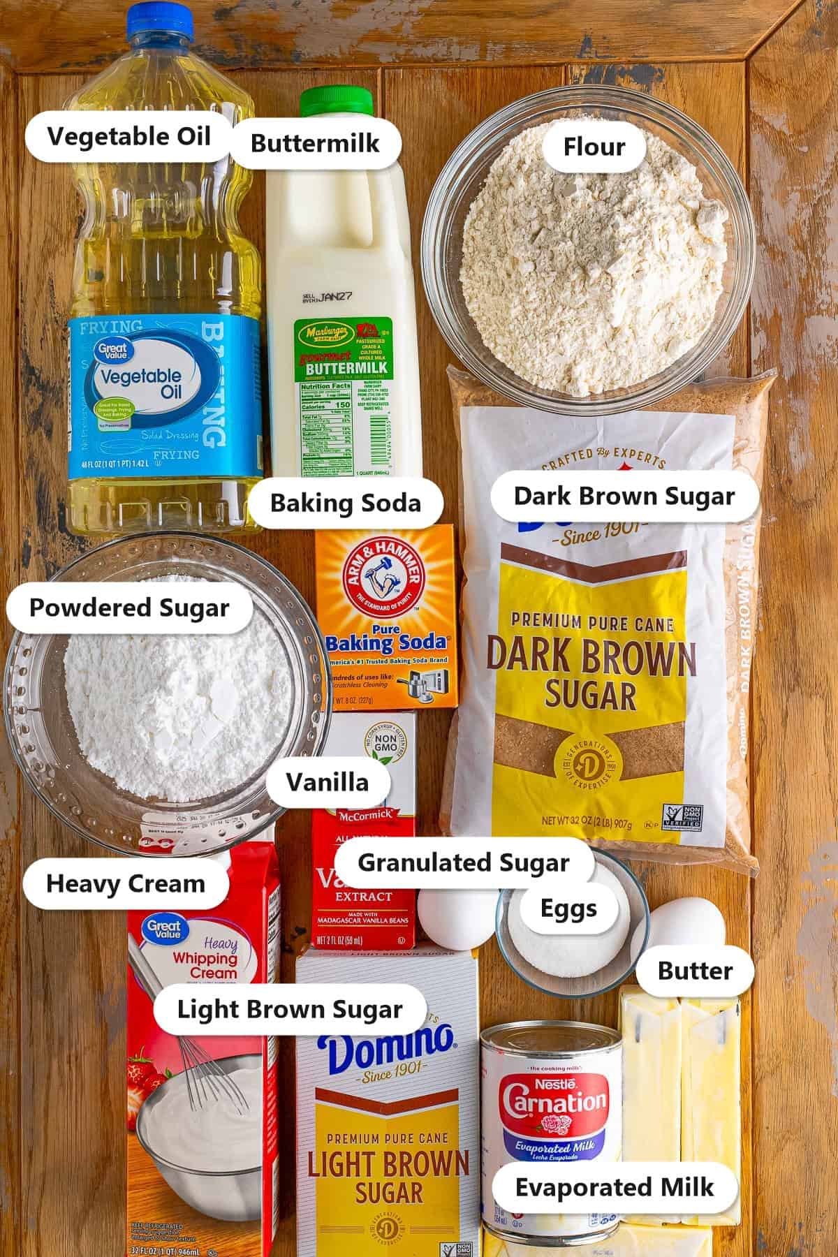 Labeled ingredients for old fashioned caramel cake including flour, brown sugars, butter, buttermilk, eggs, evaporated milk, and heavy cream.