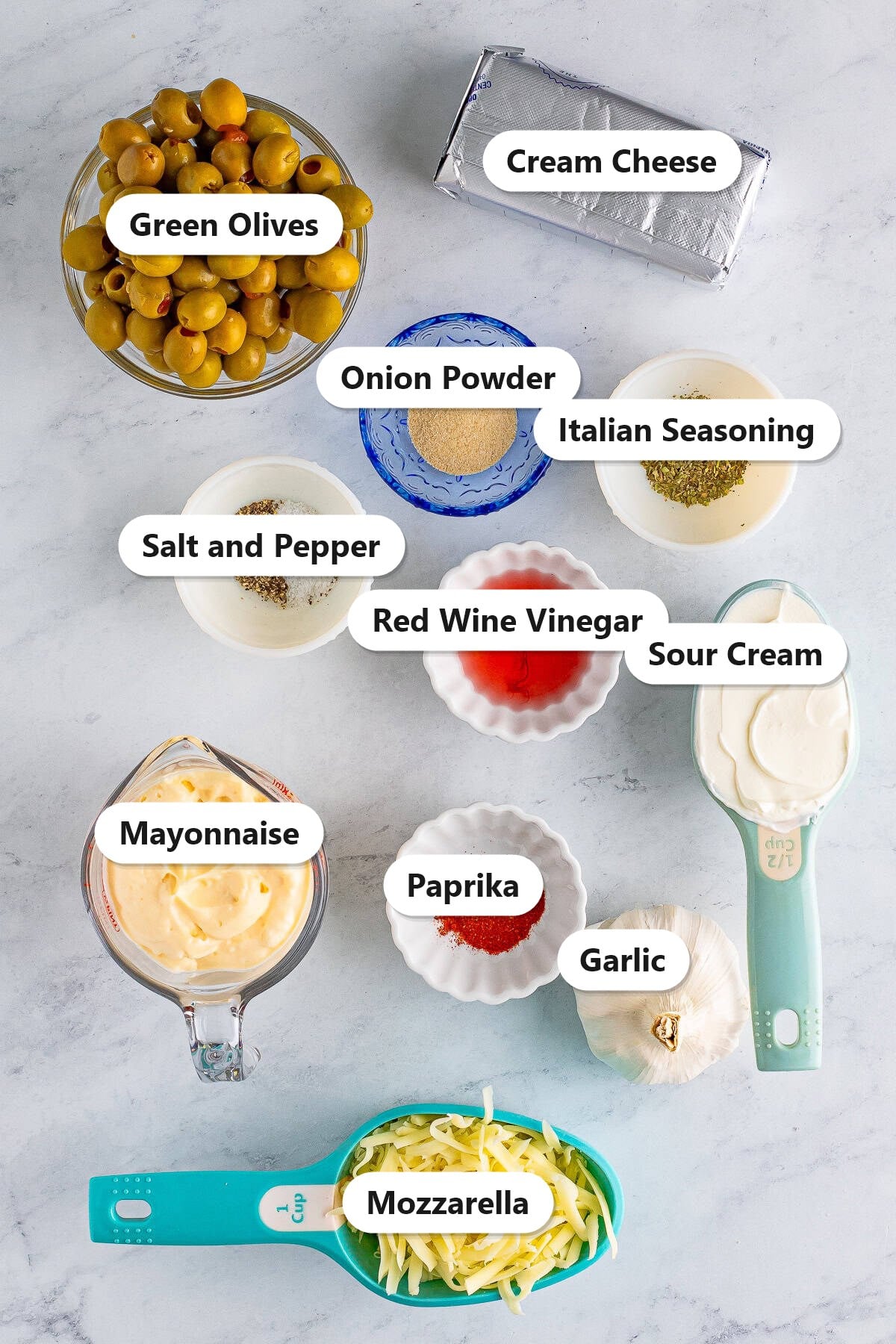 Labeled ingredients needed to make olive dip.