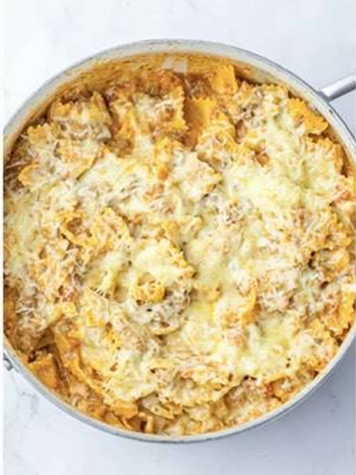 Finished one pot lasagna topped with melted cheese and parsley.