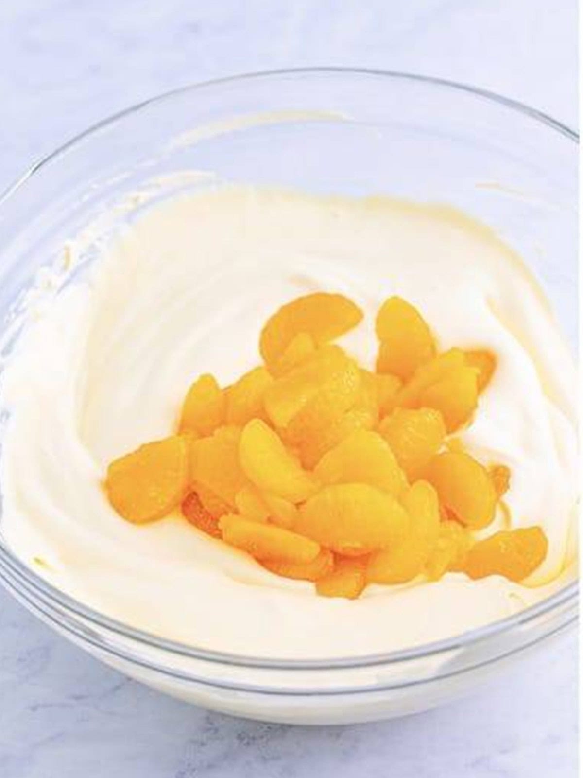 Drained mandarin oranges added to the pudding topping.