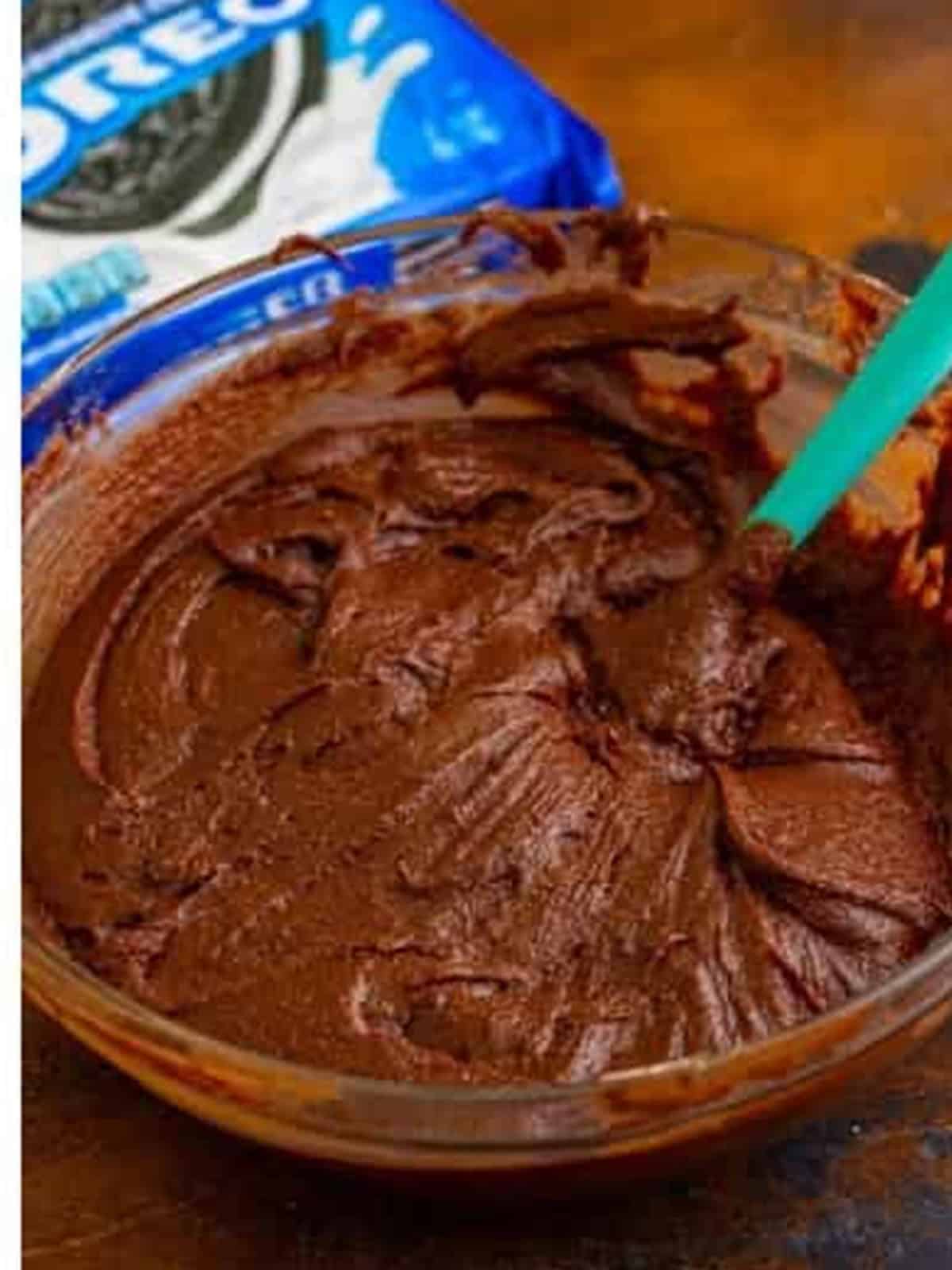 Oreo brownie batter spread in the pan, ready to layer with Oreos and bake.