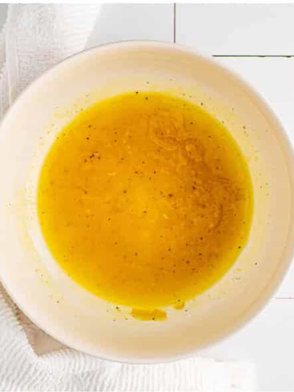 Whisked lemon honey dijon dressing in a bowl