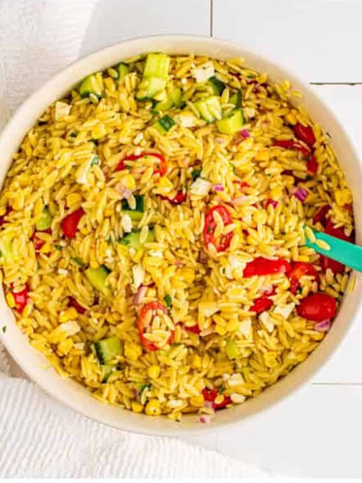 Tossed orzo pasta salad coated in dressing