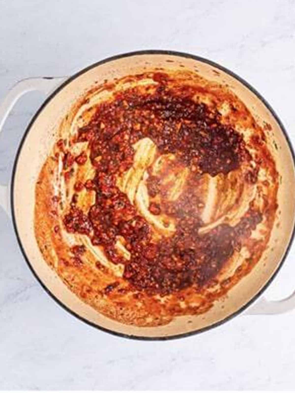 Tomato paste stirred in and deglazed with red wine in the Dutch oven.