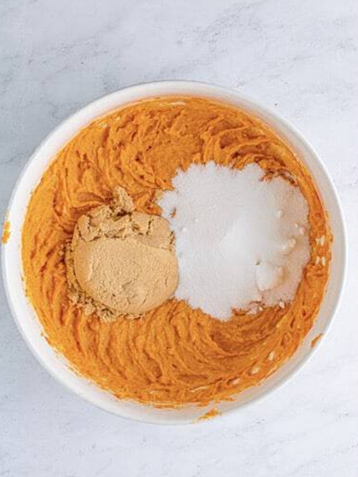 Adding brown sugar and granulated sugar to the sweet potato filling.