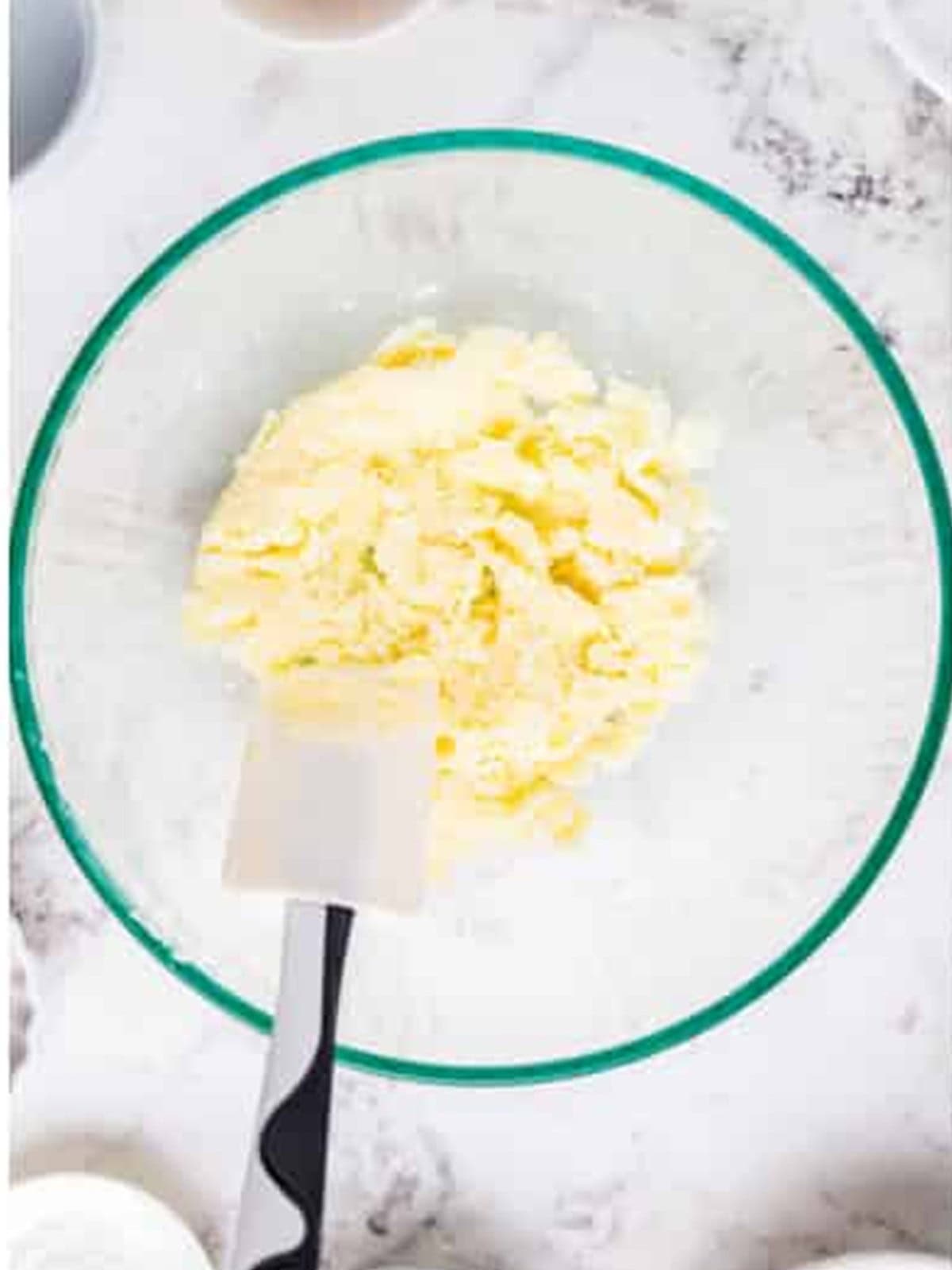 Creaming butter and sugar in a glass bowl for munchkins.
