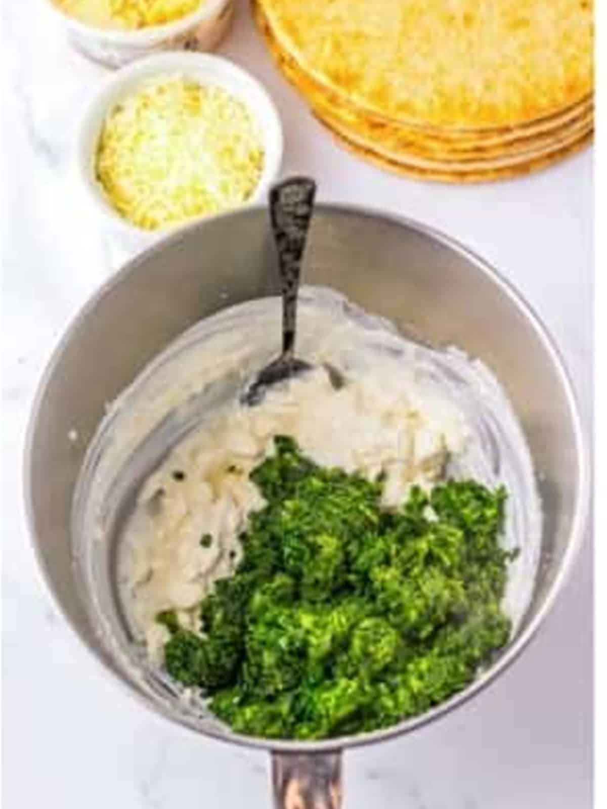Thawed spinach added to the cream cheese mixture for spinach dip.