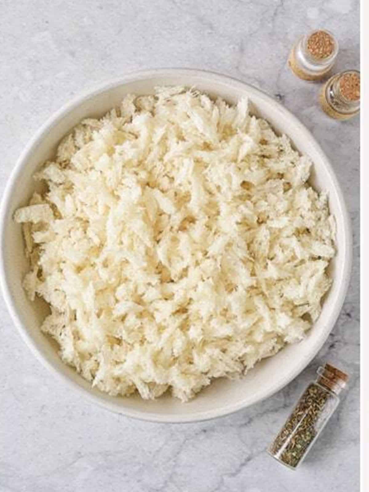 Bread torn into small pieces in a bowl for panko bread crumbs.