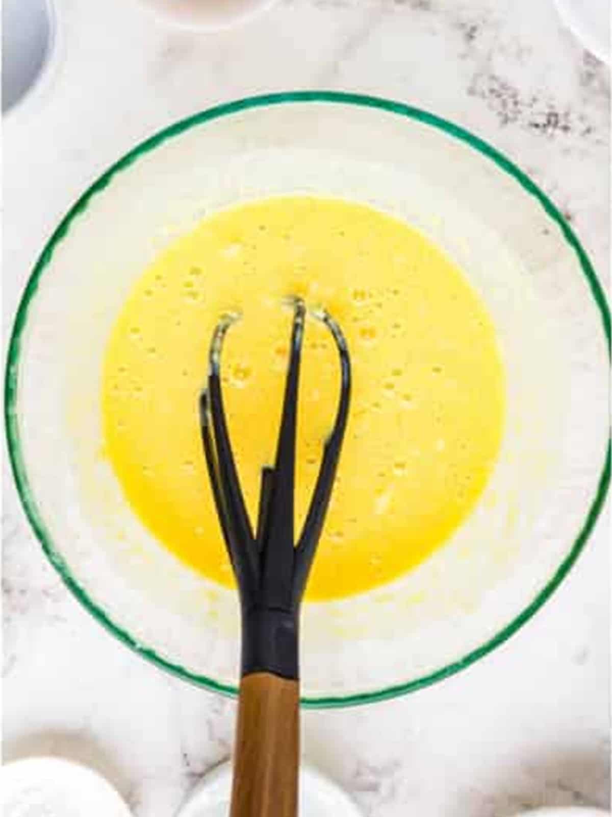 Eggs, yogurt, and vanilla whisked together for munchkin dough.